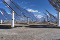 a row of solar panels with one bright yellow ball hanging above it in the sky