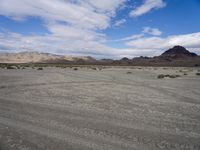 this desert is very barren and empty with grass growing in the middle of it,