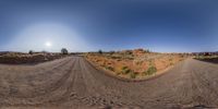 a 360 view shows the road running through a desert area in front of the sun