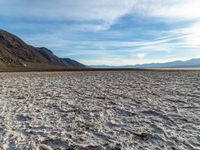 the mountains are next to the dry lake in the desert at sunset - looking down into the water