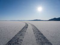 a very long track in the middle of a desert in the middle of the sun