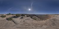 a view of the desert and sky with clouds and sunlight on it at the top