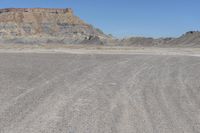 a red truck is driving through the rocky landscape of the desert of an arid area