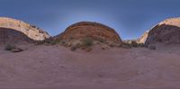 two rocks and grass in a small desert valley with the same area where the two rock are