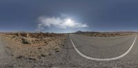 a deserted highway with a sky in the background and a cloud in the middle of the image