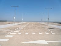 a deserted parking lot with a passenger jet coming from a runway terminal with stairs to it