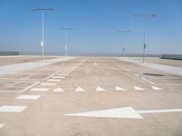 a deserted parking lot with a passenger jet coming from a runway terminal with stairs to it