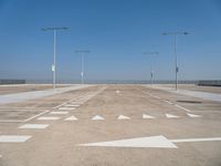 a deserted parking lot with a passenger jet coming from a runway terminal with stairs to it