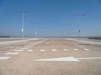 a deserted parking lot with a passenger jet coming from a runway terminal with stairs to it