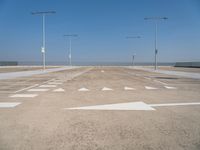 a deserted parking lot with a passenger jet coming from a runway terminal with stairs to it