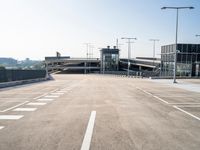 a deserted parking lot with a passenger jet coming from a runway terminal with stairs to it