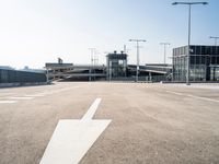 a deserted parking lot with a passenger jet coming from a runway terminal with stairs to it