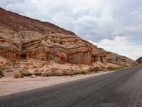 the road near a large canyon in a desert area is very deserted with no people