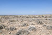 a deserted road runs through the desert in the middle of nowhere, with mountains in the distance