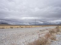 a deserted and empty road stretches out in the distance on a cloudy day in the desert