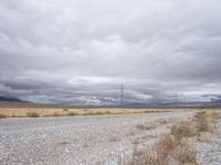 a deserted and empty road stretches out in the distance on a cloudy day in the desert