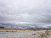 a deserted and empty road stretches out in the distance on a cloudy day in the desert