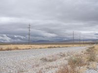 a deserted and empty road stretches out in the distance on a cloudy day in the desert