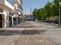 this is a very deserted and empty street in a european city this picture is taken through a window looking back to the sidewalk and street