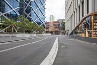 a deserted street with no one riding the bike alone in it, surrounded by buildings