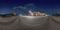 two streetlights over a deserted street at night time with the sky as background, in a fisheye - lens view