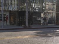 a palm tree and shops along the street in downtown los angeles, california, united