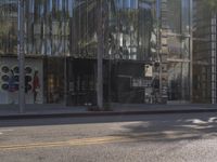 a palm tree and shops along the street in downtown los angeles, california, united