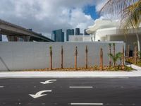 two white arrows on the road with the city skyline behind it in miami, florida