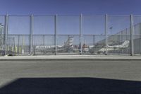 a fence is at an airport as the plane prepares to take off from the runway