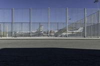 a fence is at an airport as the plane prepares to take off from the runway