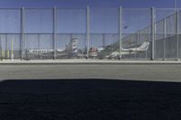 a fence is at an airport as the plane prepares to take off from the runway