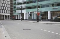 a couple of streets near buildings and a car with no front door on it and a no parking sign