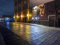 a street in the middle of an old brick street at night with neon lighting from several lights