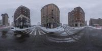 this is a picture of a city with buildings and street signs in wintertime snow