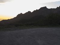 Dirt and Asphalt Road in California: Embracing the Mountain Range