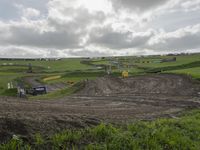 a dirt bike track that looks like a course and is almost empty as the other is