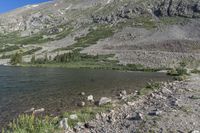 a view of a small mountain lake in the mountains near the ocean of water and rocks