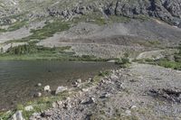 a view of a small mountain lake in the mountains near the ocean of water and rocks