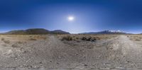 an image of a dirt road in the desert with mountains behind it in this photo