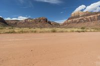 this is a dirt road and two motorcycles in the desert near a cliff wallpaper