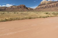 this is a dirt road and two motorcycles in the desert near a cliff wallpaper