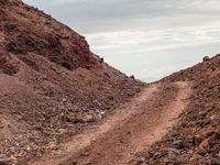 Dirt Road in a Mountain Landscape Covered in Sand