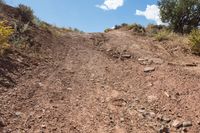 dirt road leading up to the mountains on a sunny day, in arizona's mojaz national preserve