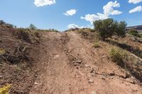 dirt road leading up to the mountains on a sunny day, in arizona's mojaz national preserve