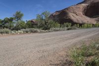 the dirt road is winding around the mountainside in this image, there is no parking spaces