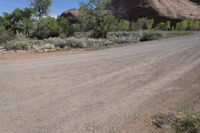 the dirt road is winding around the mountainside in this image, there is no parking spaces