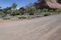 the dirt road is winding around the mountainside in this image, there is no parking spaces