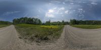 three views of dirt roads next to a green grass field and woods with sun and cloud in sky