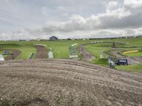 a group of motorcycle racers are going down a dirt track at a motorcycle race competition