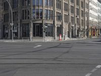 two people in red jackets are on a skateboard and crossing street at an intersection